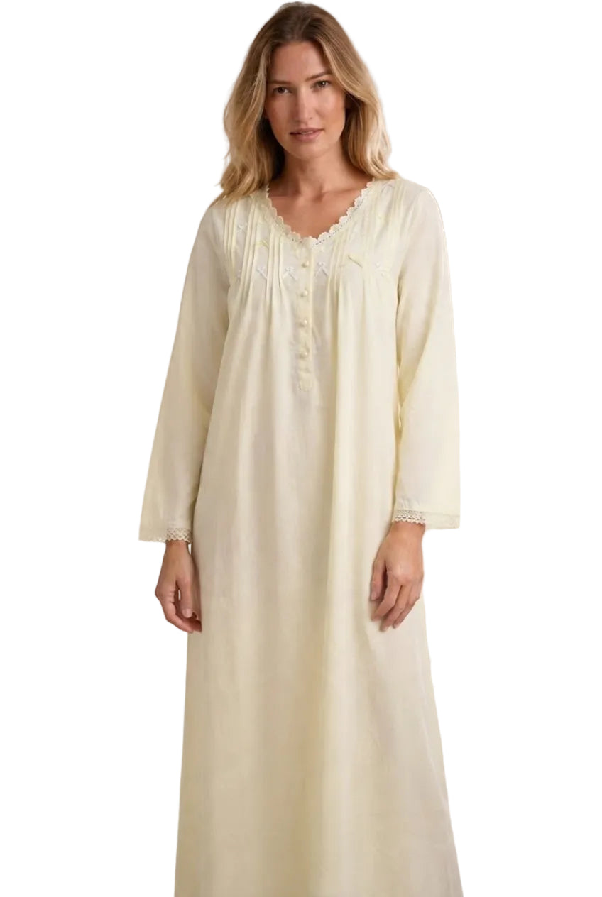 Beige long abaya with V-neckline, button placket, pin-tucks, floral embroidery, and lace trim on neckline and cuffs.