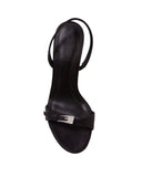 Overhead view of the Black Suede Studio black satin sandal showing the leather footbed with brand logo and the sparkling rhinestone buckle detail.
