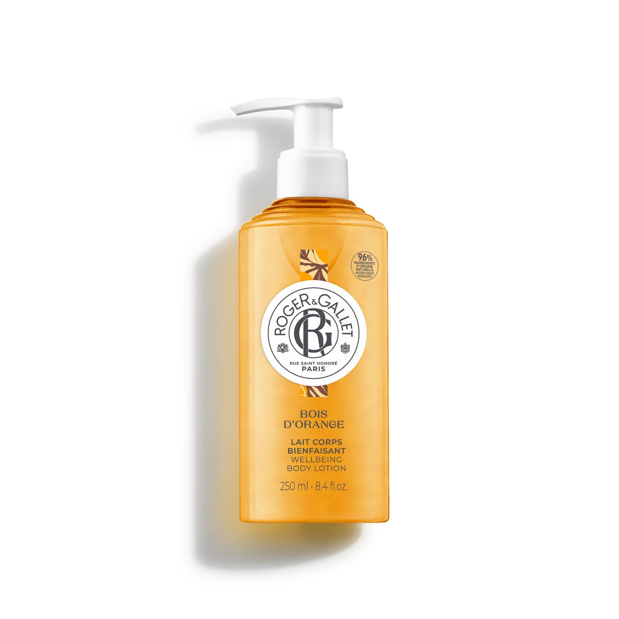 A 250ml orange translucent pump bottle of Roger & Gallet Bois d'Orange Wellbeing Body Lotion, featuring a white pump dispenser and a central round logo.