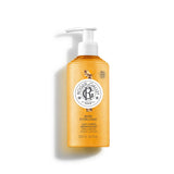 A 250ml orange translucent pump bottle of Roger & Gallet Bois d'Orange Wellbeing Body Lotion, featuring a white pump dispenser and a central round logo.