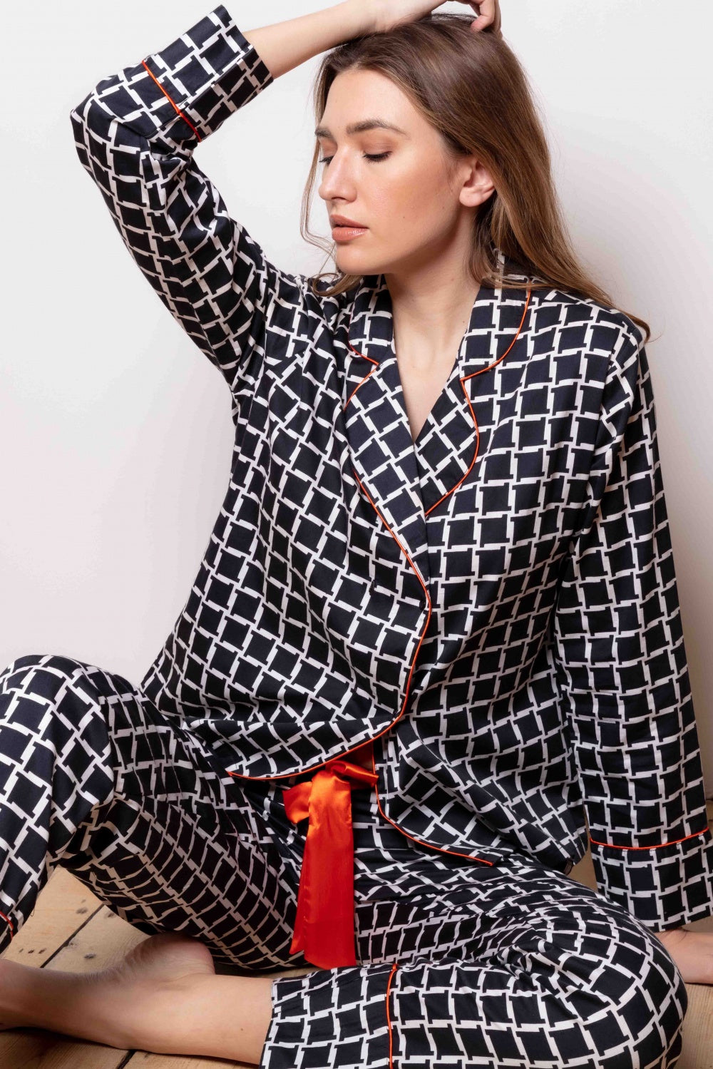 Black and white geometric print cotton sateen pajama set with orange piping on the revere collar, cuffs, and front opening, p