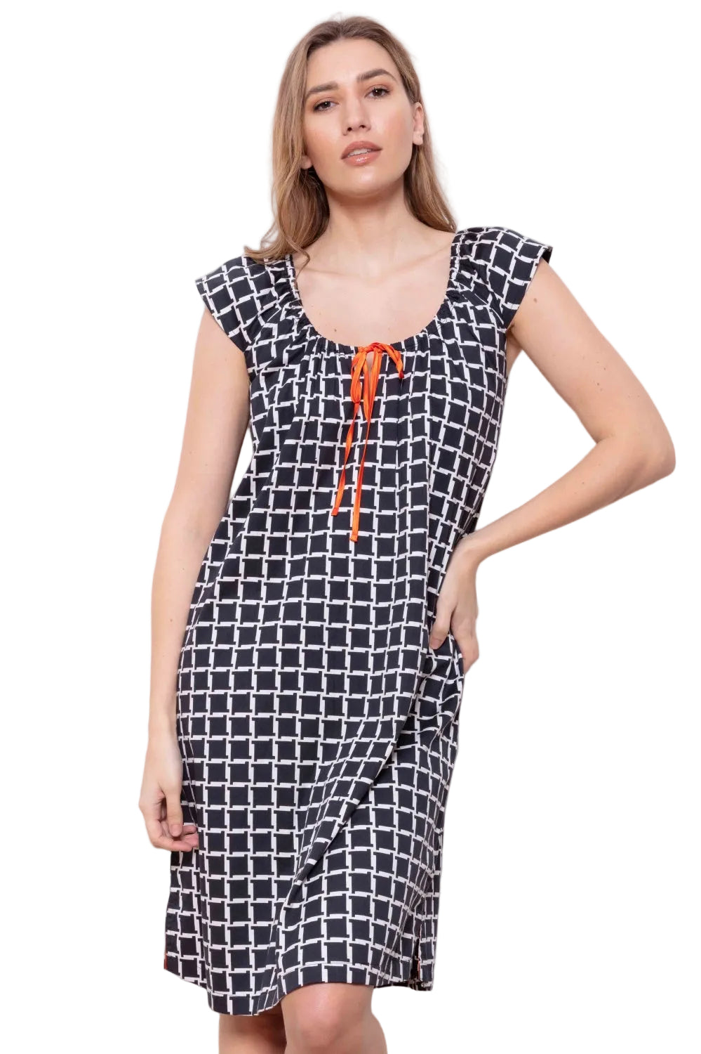 Black and white geometric cube pattern lounger dress with a ruched scoop neck and orange ribbon tie.