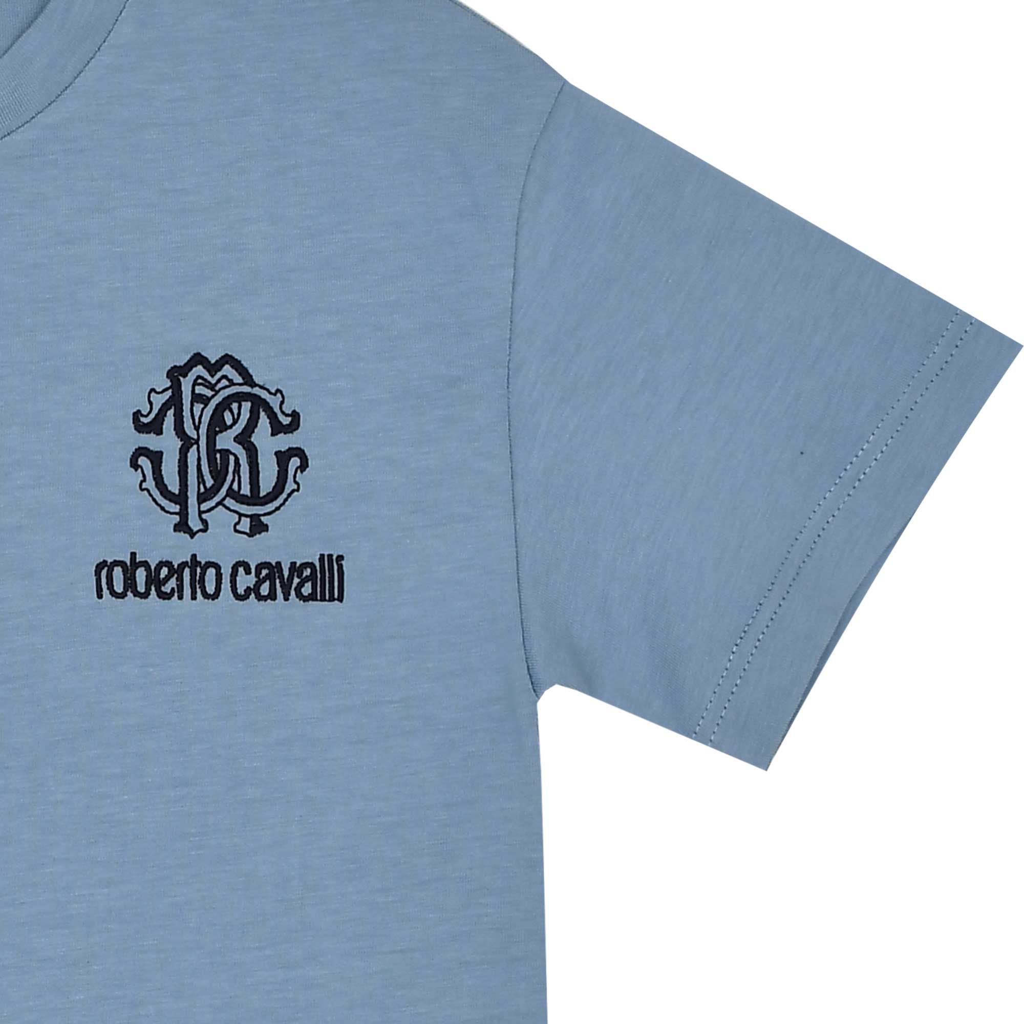 Close-up shot of the Roberto Cavalli blue t-shirt, detailing the black embroidered chest logo and the patterned inner neckline trim.