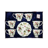 A top-down view of the Royal Family 12-piece tea set arranged in a blue silk-lined gift box, showing six floral teacups and a stack of matching saucers.