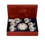 Perspective view of the open red Royal Family luxury gift box containing the gold and white porcelain coffee service and an authenticity card.