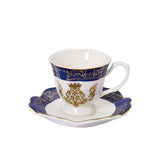Close-up of a Royal Family porcelain tea cup and scalloped saucer featuring cobalt blue trim, gold filigree, and a crowned crest on a white background.