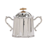 A symmetrical silver-plated sugar bowl with two ornate handles and a fluted dome lid.