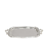 High-angle shot of a polished silver serving tray by Royal Family, highlighting the reflective surface and detailed scrollwork on the side handles.