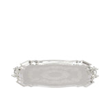 Elevated perspective of a Royal Family silver tray highlighting the intricate filigree engraving in the center and the decorative scalloped rim.