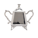 A symmetrical silver-plated sugar bowl with two ornate scroll handles and a matching footed base.