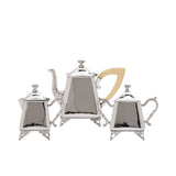 A three-piece Royal Family silver-plated tea set featuring a teapot, sugar bowl, and creamer on ornate silver feet against a white background.