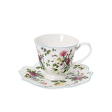 A close-up of a single Royal Family teacup resting on its scalloped saucer, highlighting the detailed rose pattern and light blue rim.