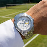 Silver-toned metal watch with a white chronograph dial, yellow accent on one sub-dial, date window, and link bracelet.
