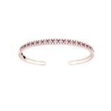 Silver-toned open cuff bangle with a top row of rectangular ruby-colored stones flanked by clear round stones.