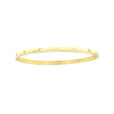 Gold-toned bangle bracelet with six evenly spaced clear round stones