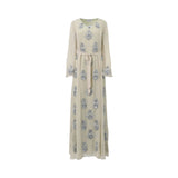 Front view of a SHAIRA champagne-colored maxi dress featuring silver floral sequin embellishments, long sleeves, and a matching waist tie.