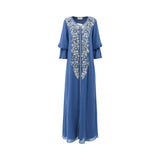 Front view of a SHAIRA blue long-sleeved Jalabiya featuring heavy silver floral embroidery and sequins down the center with tiered ruffle sleeves on a white background.