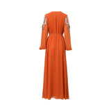 Back view of a SHAIRA orange floor-length gown showing the flowing chiffon fabric, cinched waist, and silver embellishments on the shoulders.