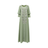 Front view of a SHAIRA sage green long-sleeved Jalabiya featuring heavy silver floral embroidery and sequins down the center with tiered ruffle sleeves on a white background.