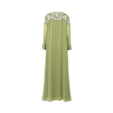 The back of the SHAIRA green kaftan showing intricate floral embroidery across the shoulders and a flowing chiffon silhouette.