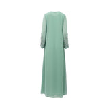 Back view of a SHAIRA mint green long-sleeved chiffon jalabiya with intricate silver floral embroidery on the chest and cuffs, displayed on a white background.