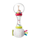 Sophie La Girafe soft maracas rattle with a clear top globe containing a beige giraffe figure, a clear hourglass section with
