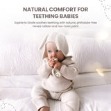White ring teether with a small white Sophie La Girafe figure, featuring black spots and eyes.