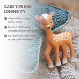 Brown fawn toy with white spots on its back, white face marking, white inner ears, and white hooves. Black eyes and nose.