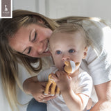 Brown fawn-shaped teether with white spots and a white face.
