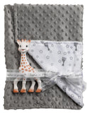 Grey plush baby blanket with raised dots, folded, featuring a white patterned panel and a Sophie La Girafe teether.