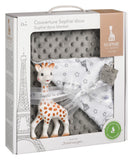 Grey dotted minky blanket, white blanket with grey stars and giraffe heads, and a white and orange-spotted Sophie La Girafe t
