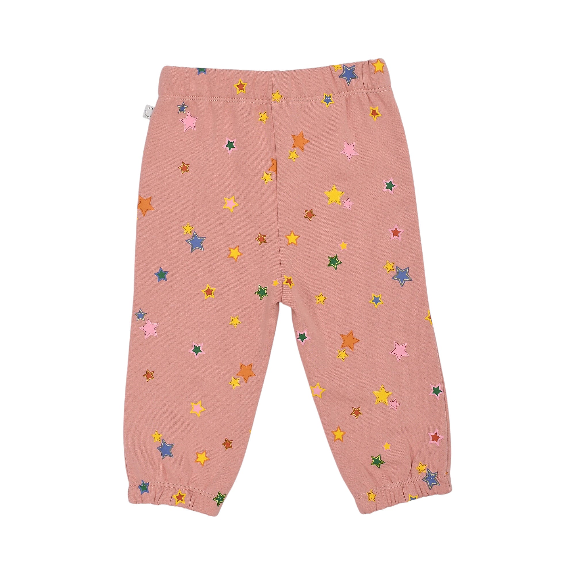 Soft pink jogging pants with an elasticated waist and cuffs, covered in scattered multi-colored stars of various sizes.