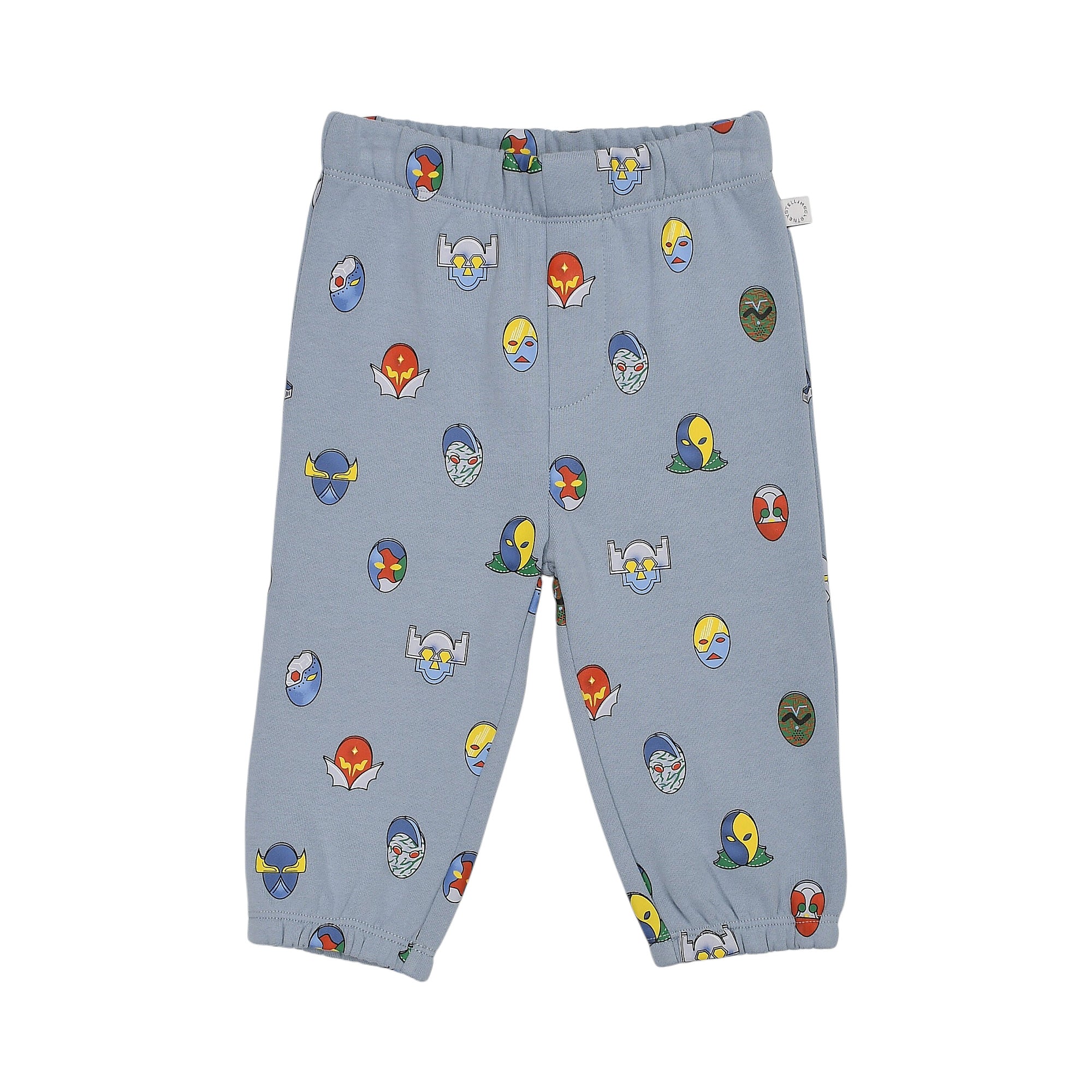 Light blue jogging pants with an elastic waist and cuffs, featuring an all-over print of colorful cartoon masks.