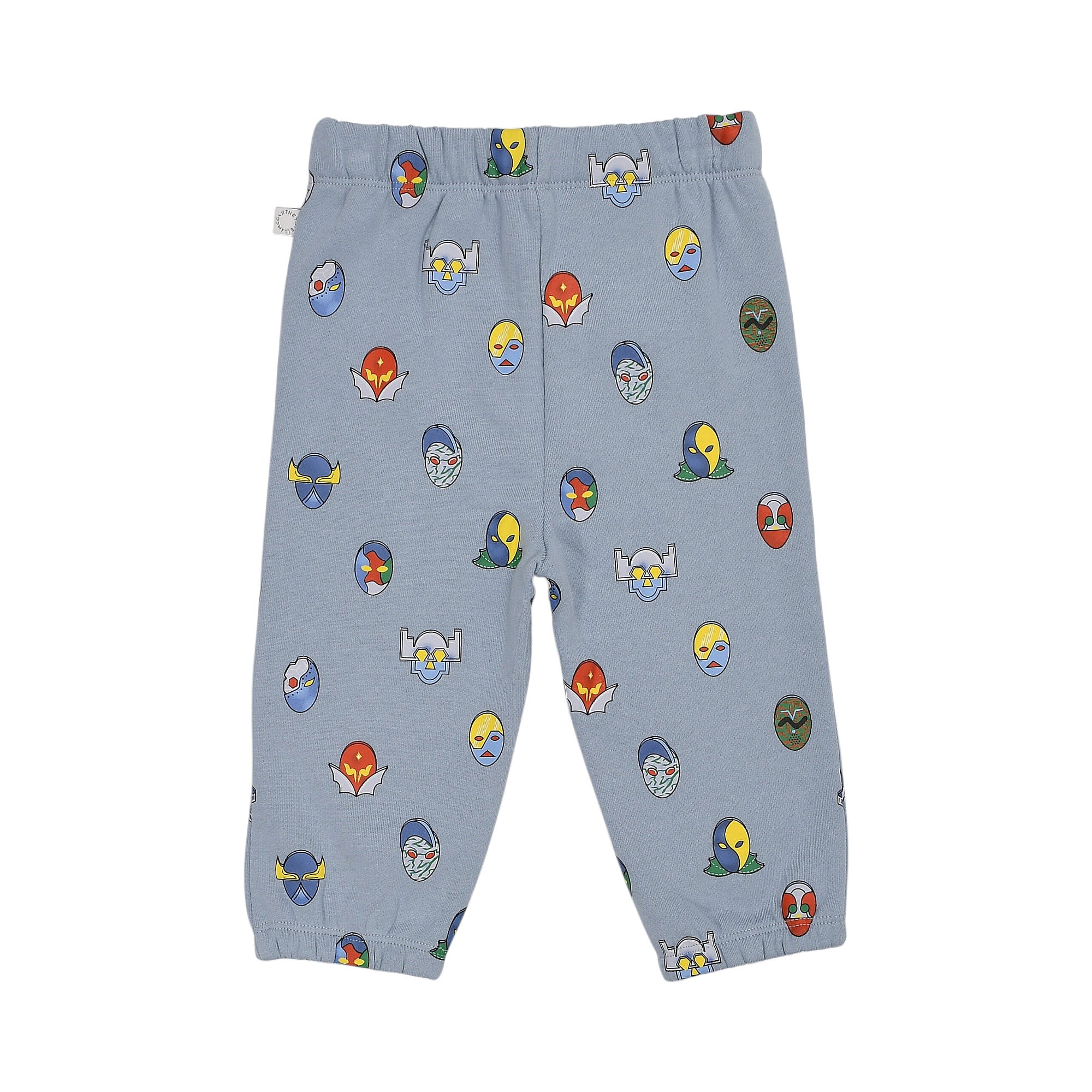 Light blue jogging suit pants with an elasticated waist and cuffs, featuring an all-over print of colorful cartoon masks.
