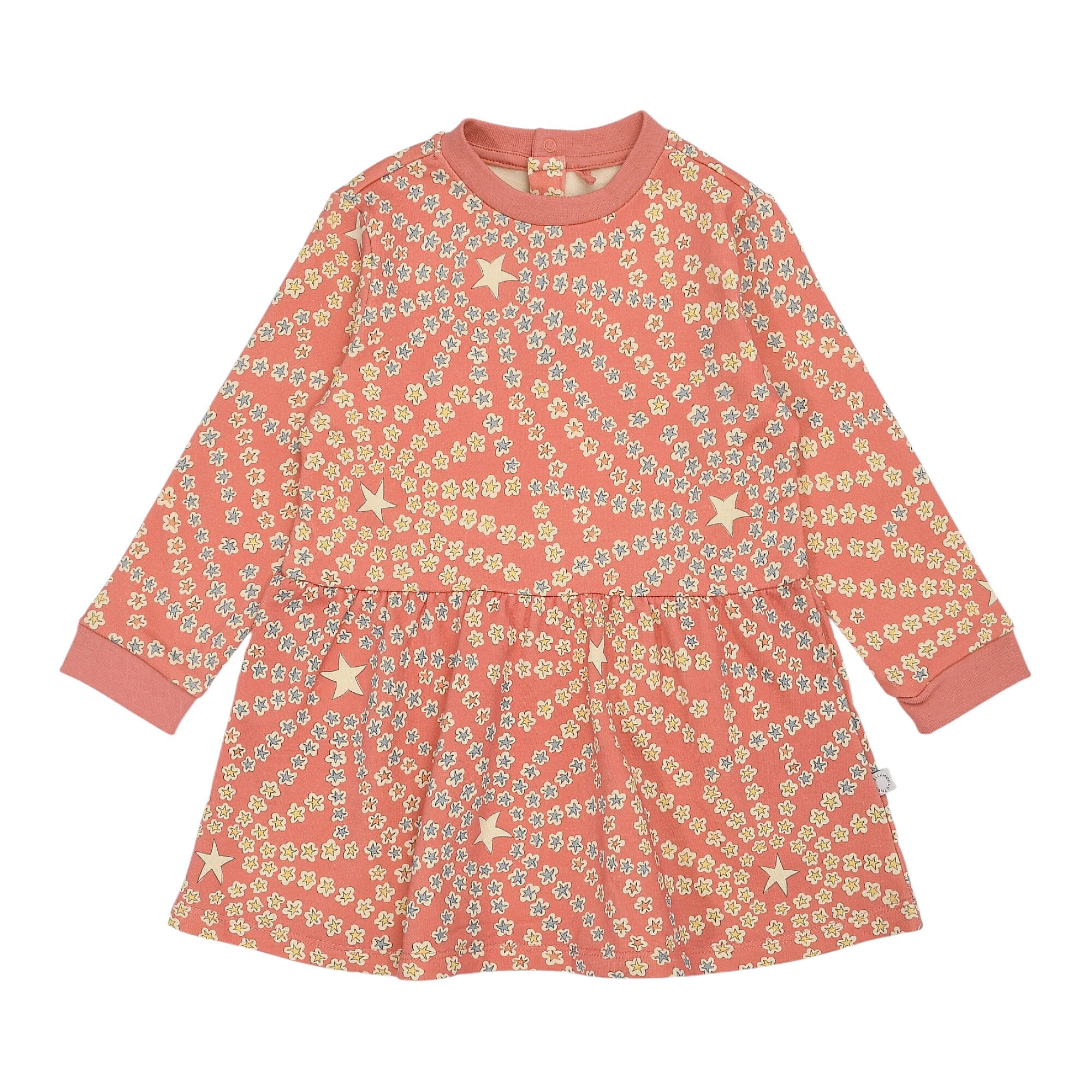 Coral pink long-sleeved baby dress with a gathered skirt, featuring an all-over pattern of yellow flowers and cream stars.