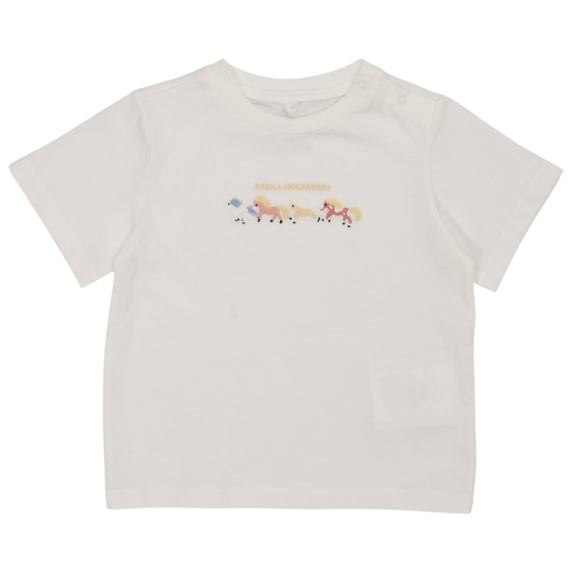 White short-sleeved t-shirt with a crew neck and snap buttons on the left shoulder, featuring a colourful pony graphic print.