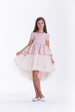 Pink dress with a square neckline, short puffed sleeves, and a tiered high-low skirt with a cream tulle overlay.