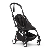 Black Stokke YOYO3 stroller frame with a padded seat, five-point harness, under-seat storage, and white-rimmed wheels.