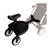 Black Stokke YOYO Stroller Board with a black contoured seat and three wheels with white rims, attached to a stroller.