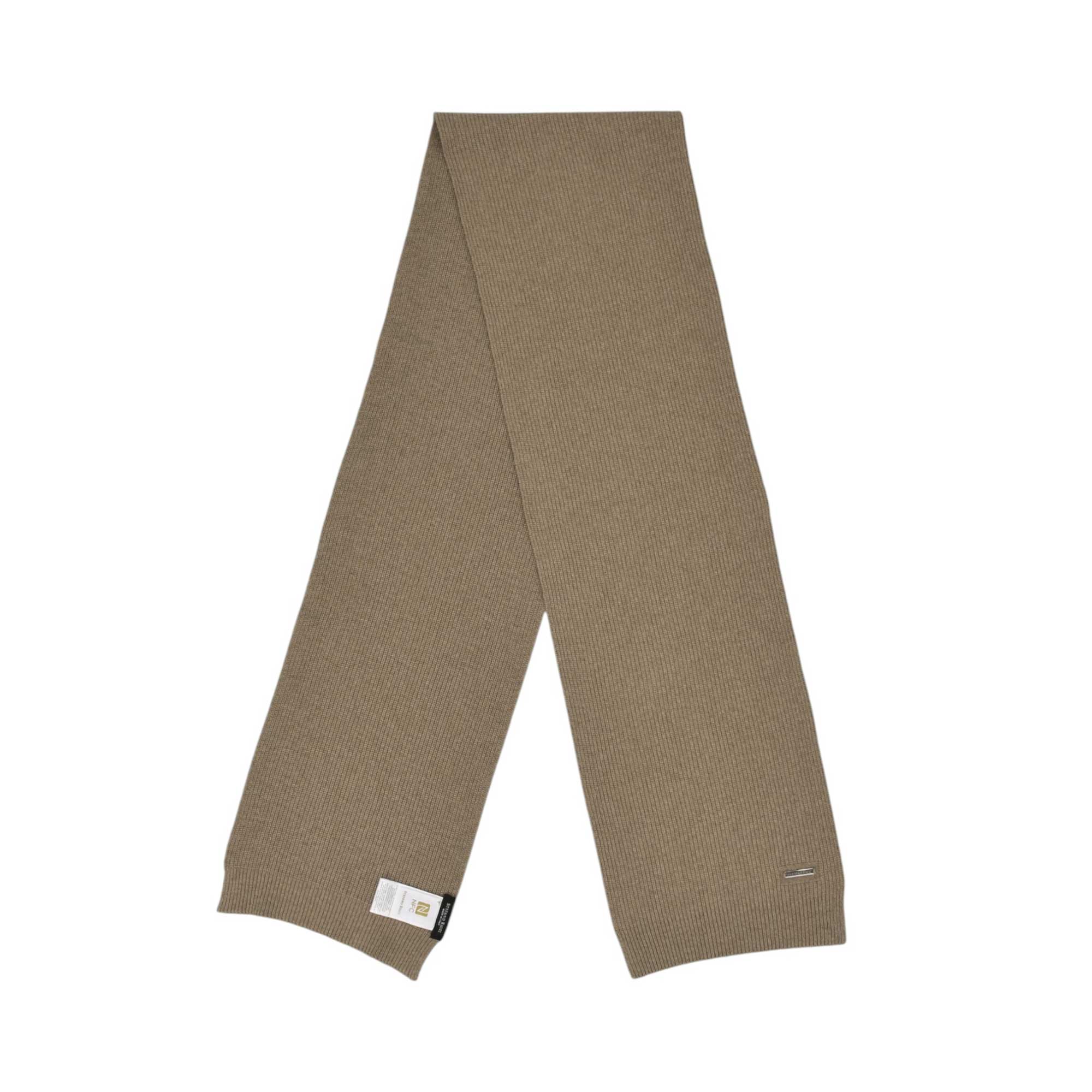 Beige ribbed knit scarf with a small metallic plaque near one end and a fabric label on the other.