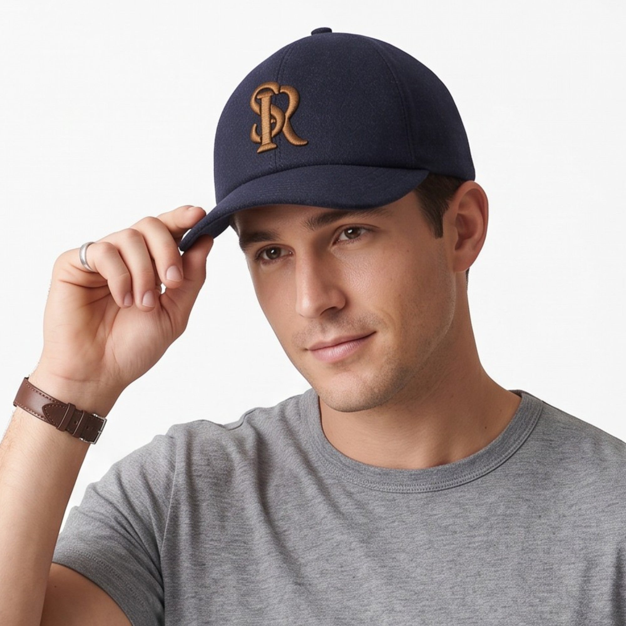 Navy blue felt baseball cap with a gold-toned embroidered interlocking 'JR' monogram on the front.