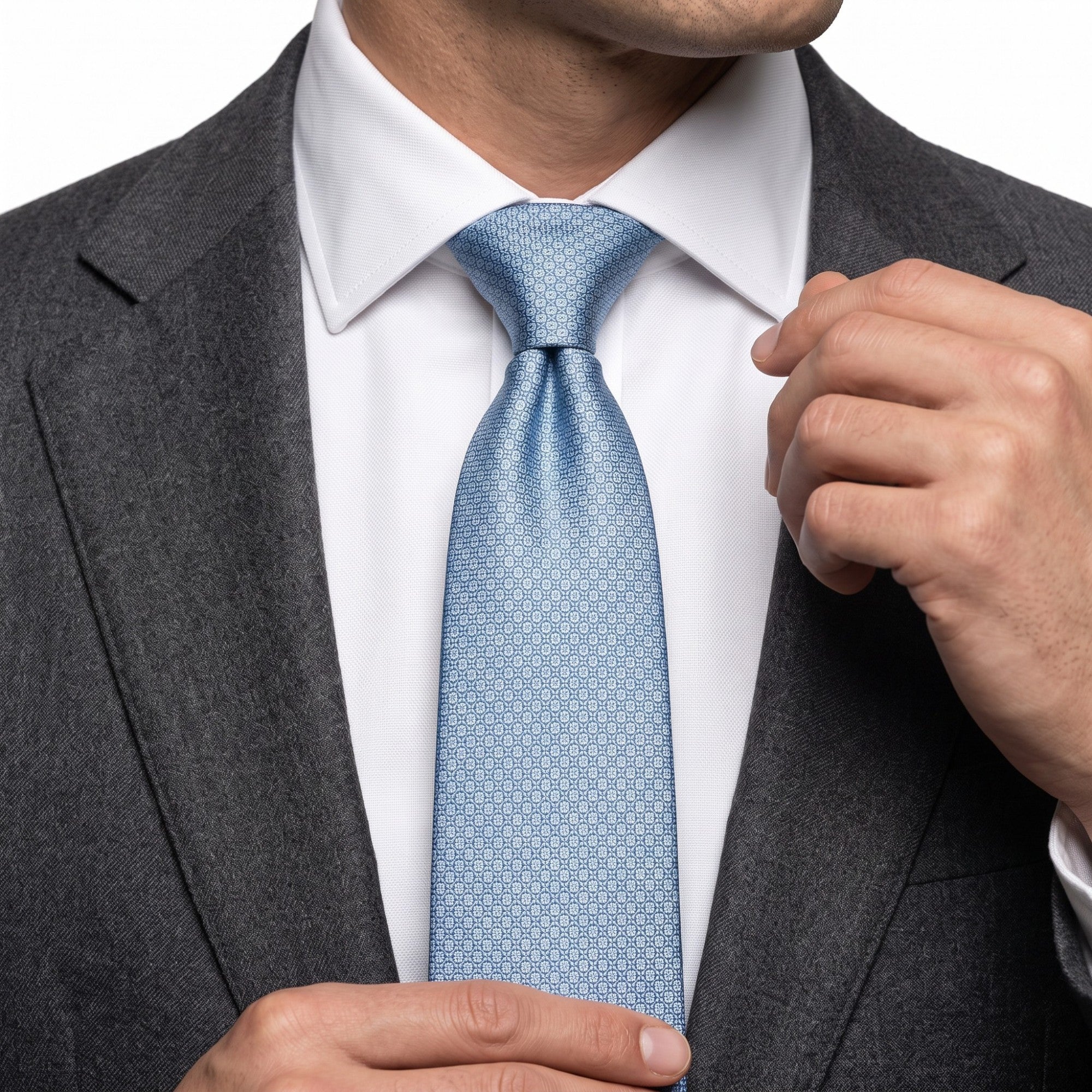 Light blue necktie with a subtle, repeating pattern of small, light blue geometric shapes.