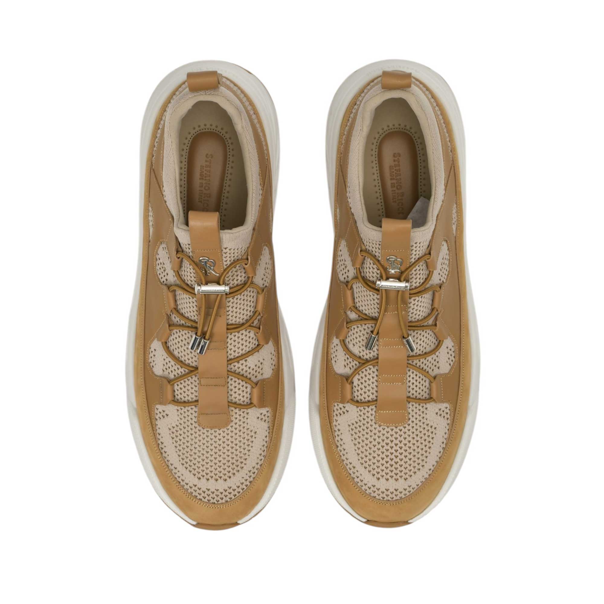 Pair of brown and beige mesh sneakers with leather overlays, elastic laces, silver-toned toggles, and thick white soles.