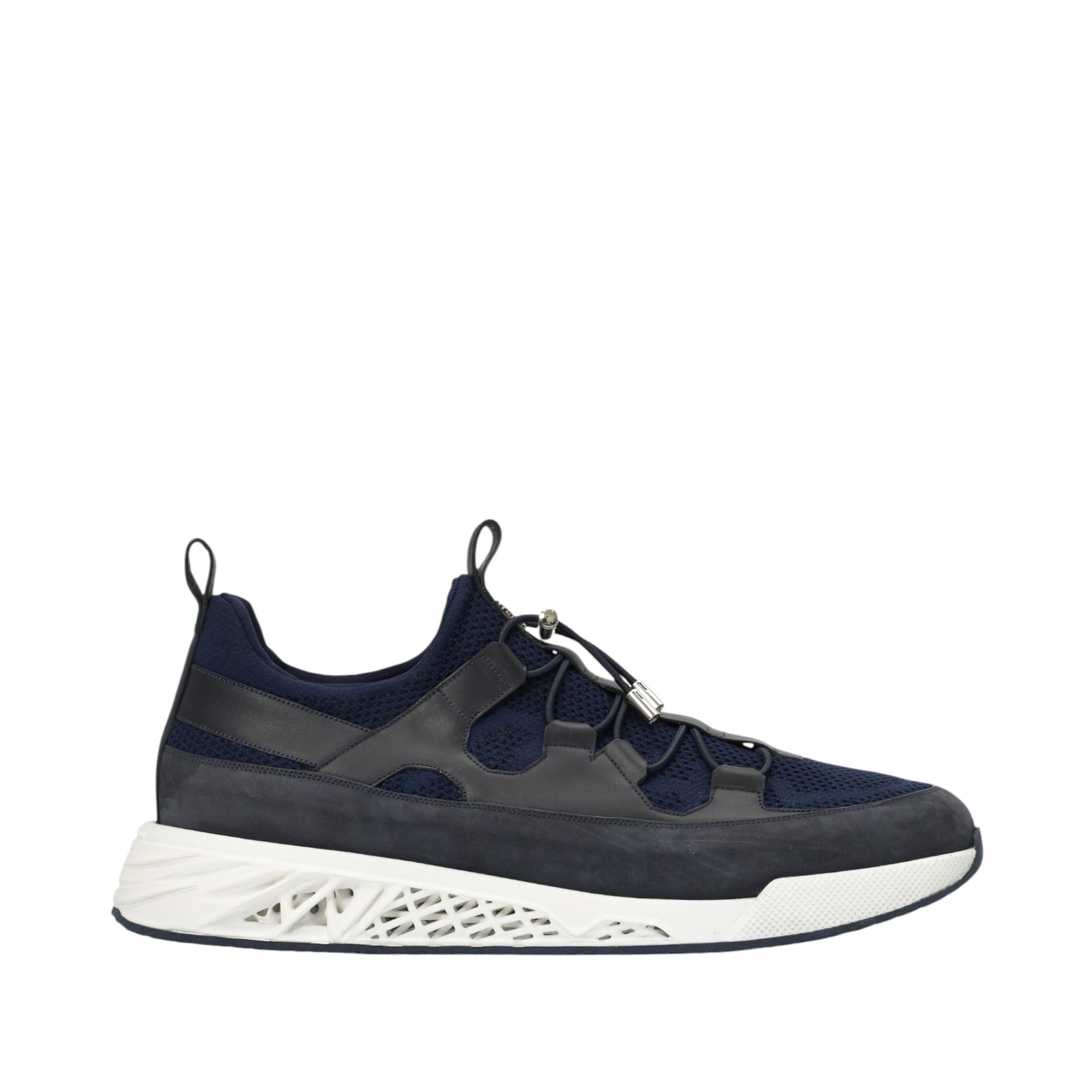 Navy blue low-top trainers with mesh and suede panels, dark grey leather overlays, white geometric sole, and silver-toned tog