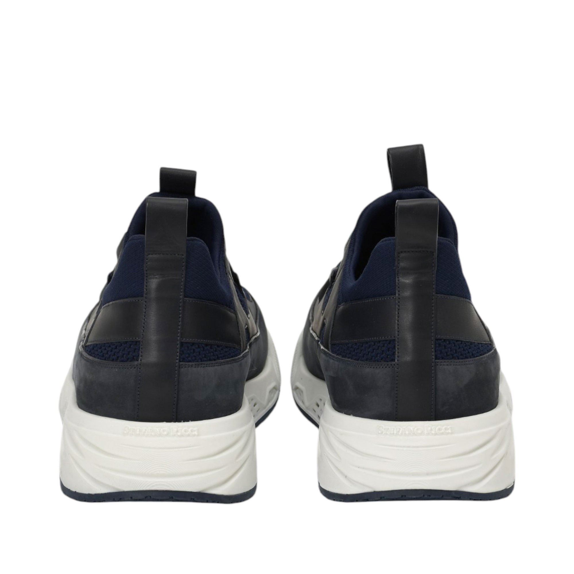 Pair of navy blue sneakers with mesh and leather panels, black pull tabs, and thick white soles with 'SERAFINO RICCI' text.