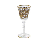 A single crystal wine glass featuring intricate 24k gold filigree, a beaded stem, and a gold-trimmed base.