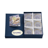 An angled shot showing the six-piece Italian crystal set nestled in protective white packaging with an authenticity card.