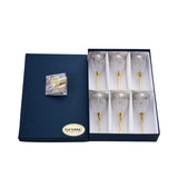 An angled shot showing the secure white-lined interior of the luxury box holding six gold-stemmed Italian crystal glasses.