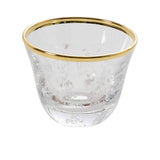 A single crystal espresso cup showing a textured silver mottled design and a bright 24k gold rim
