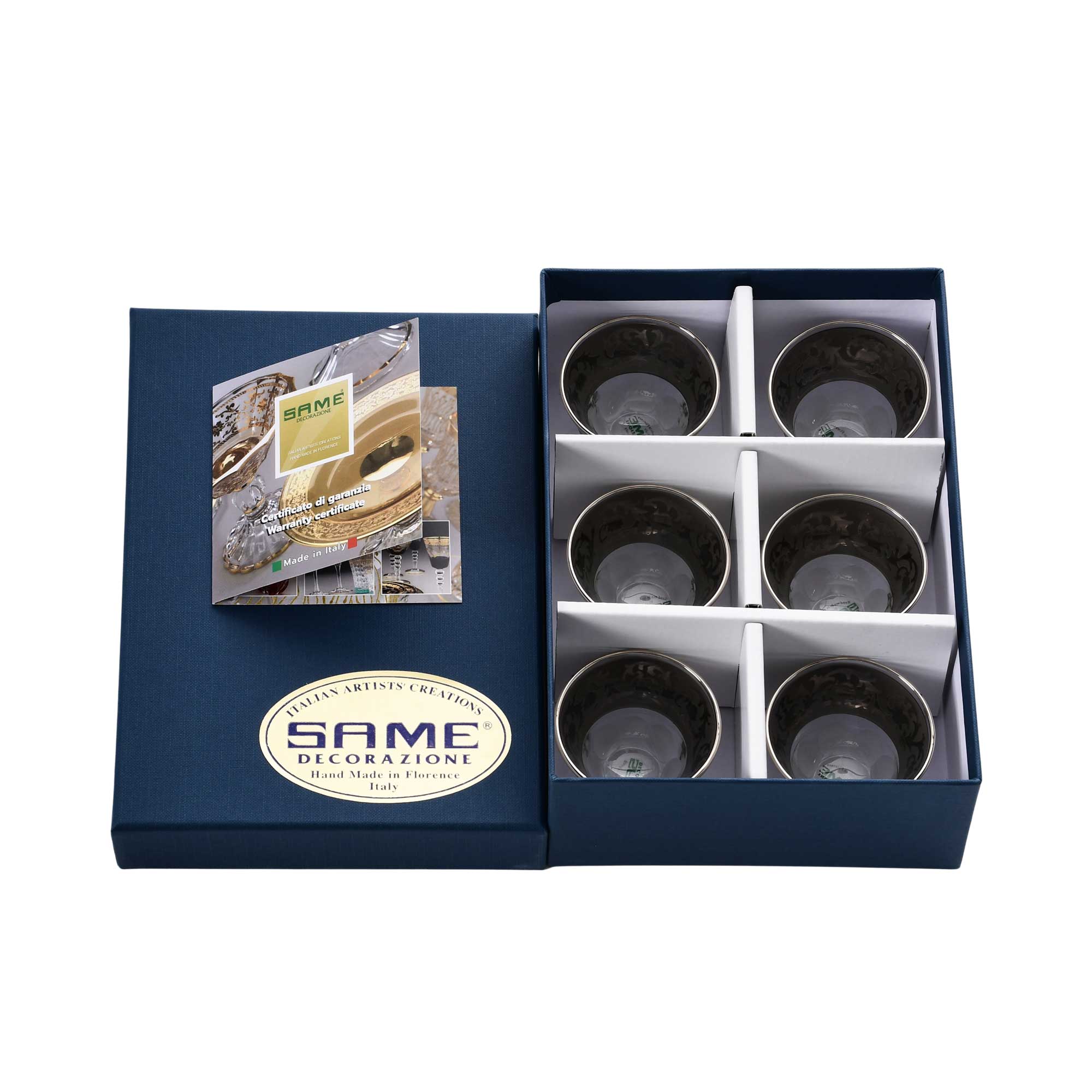 An angled view of the six-piece Italian crystal cup set resting in their protective white presentation inserts.